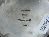 a close up of a silver plate with a label on it