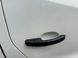 a close up of a door handle on a white car