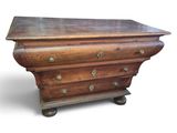 an old wooden chest of drawers with brass knobs on top