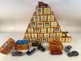 many toy cars and boxes stacked on top of each other