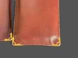 a brown leather wallet with a gold clasp on it