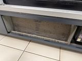 a radiator in the middle of the floor next to a window
