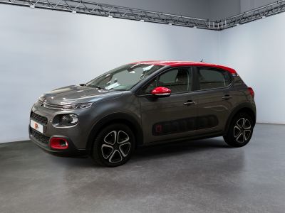 the grey and red citrole is parked in the garage