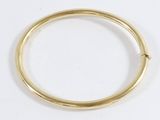 a close up of a gold ring on a white surface