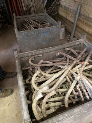 a crate full of wood sticks and nails in a room