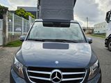a car with a box on top of it parked in a parking lot
