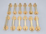 six rows of gold colored metal tubes with a white background