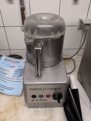 a silver blender sitting on a counter in a kitchen