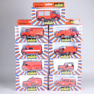 six petits camions rouges dans une vitrine