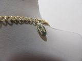 a close up of a gold chain bracelet with a charm on it
