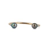 a close up image of a black pearl and diamond cuff bracelet