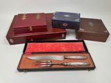 several different types of knives and knives in a box on a table