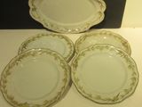 four plates are sitting on a table in front of a black wall