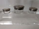 three salt and pepper shakers on display in a glass case