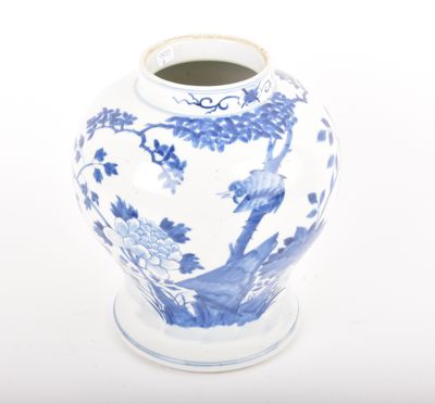 a blue and white vase sitting on a white surface