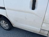 a dirty white van parked on the side of the road