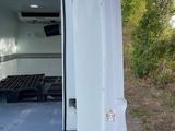 a white van with the door open on the side of the road