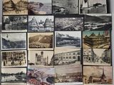 a lot of old pictures of different cities on the wall