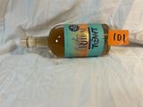 a bottle of liquor sitting on a white sheet