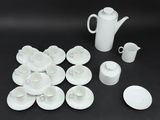 a picture of a white tea set on a black table