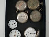 a box with many different types of pocket watches in it