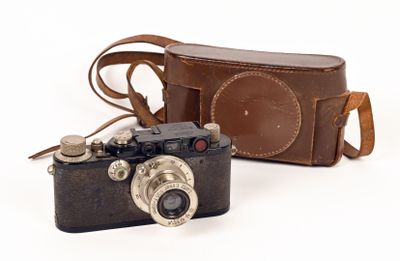 a camera and a case sitting next to each other on a white surface
