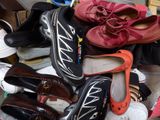 many pairs of shoes that are sitting on the floor