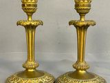 pair of antique brass candlesticks on a white background