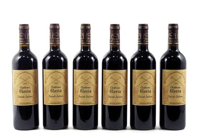 four bottles of wine are lined up on a white surface