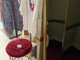 a small stool in front of a mirror in a store