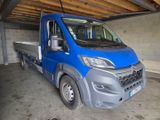 a blue truck that is parked in a garage