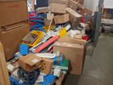 a large pile of boxes and other items in a warehouse