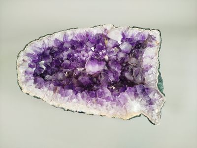 a close up of a piece of amethorate with purple crystals