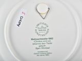 a white plate with a tag on it and a tag on the plate