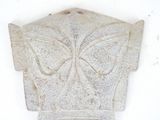 a stone sculpture of a butterfly on a wall