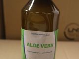 a bottle of aloe vera sitting on a cardboard box