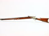 an old gun with a wooden barrel and a metal handle