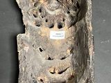 a piece of wood with a face on it