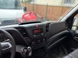 dashboard view of a car with a red fire hydrant in the background