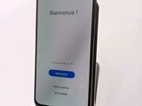 an image of a cell phone with a blue button on the screen