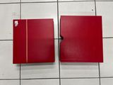 two red boxes sitting on a tiled floor