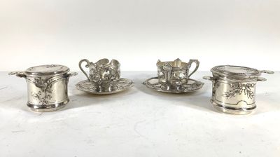 three silverplated tea cups and saucers on a white surface