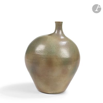 un vase brun posé sur une surface blanche