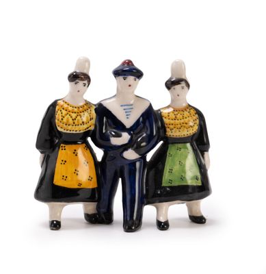 three figurines of people standing next to each other