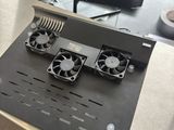 a desk with a computer and a fan on it