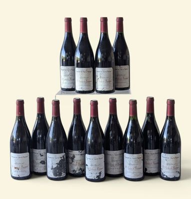 bottles of wine are lined up in a pyramid on a table