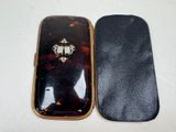 two cell phones sitting next to each other on a table
