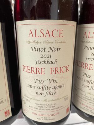 several bottles of wine are lined up on a shelf