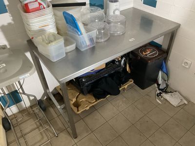 a kitchen with a stainless steel table and a sink