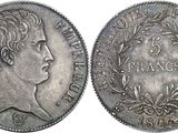 a silver coin with a woman ' s head and laurels on it